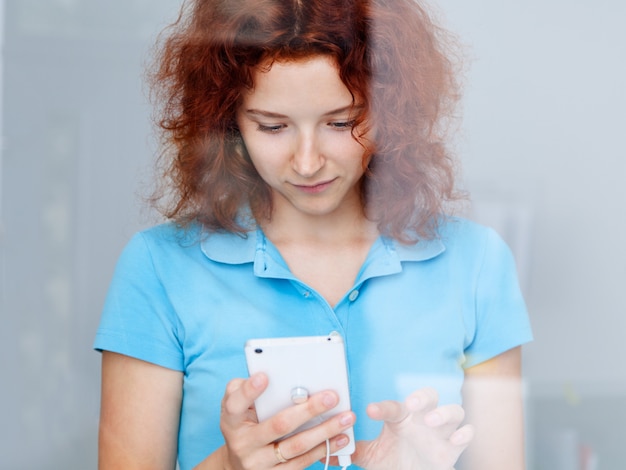 Woman choosing a mobile phone in the shop