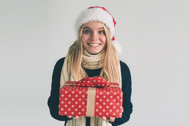 Woman in a Christmas hat holding gifts