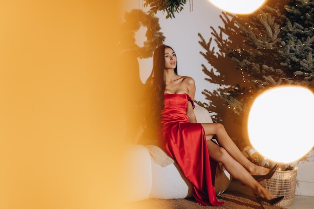 Woman on the Christmas interior background Portrait of a beautiful brunette woman with evening makeup