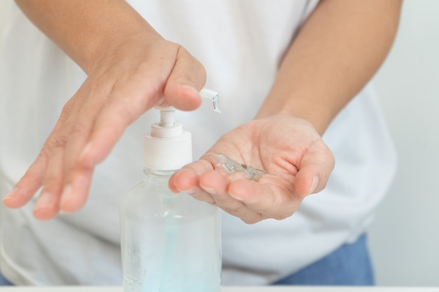 Woman clean hand with alcohol gel