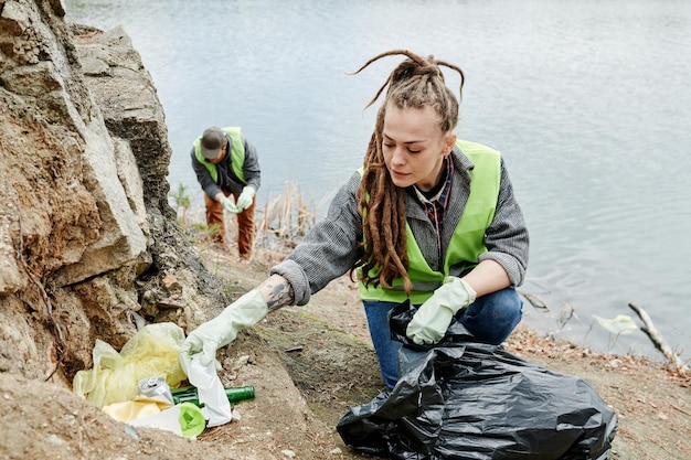 Woman Cleaning Lakeshore