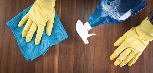 Woman cleaning wooden table at home