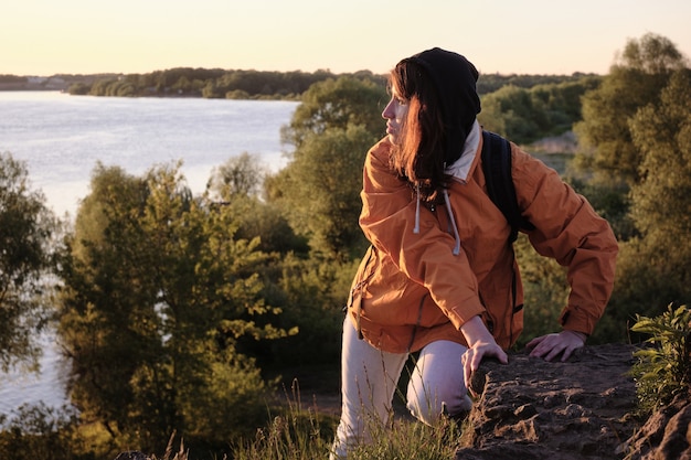 Woman climbs a rocky mountain