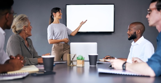 Photo woman coaching and presentation in meeting with mockup screen for team strategy or project management at office female person coach or mentor with smile in staff training on mock up at workplace