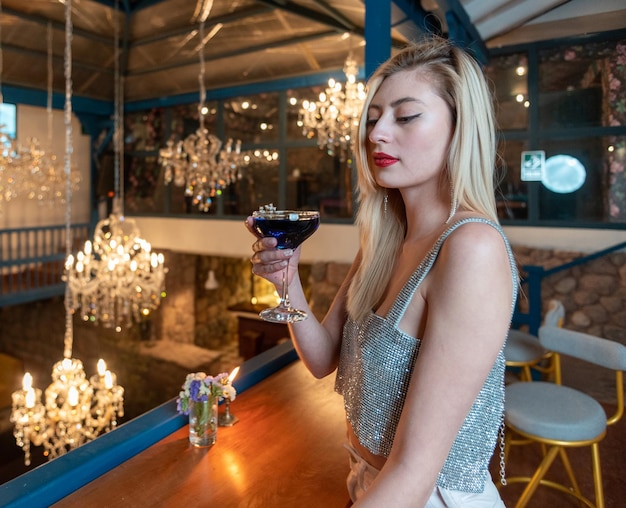 Woman in a colonial house having a cocktail.