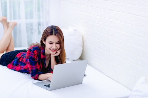 The woman and the computer in the white room Happy work The concept of happy working at home