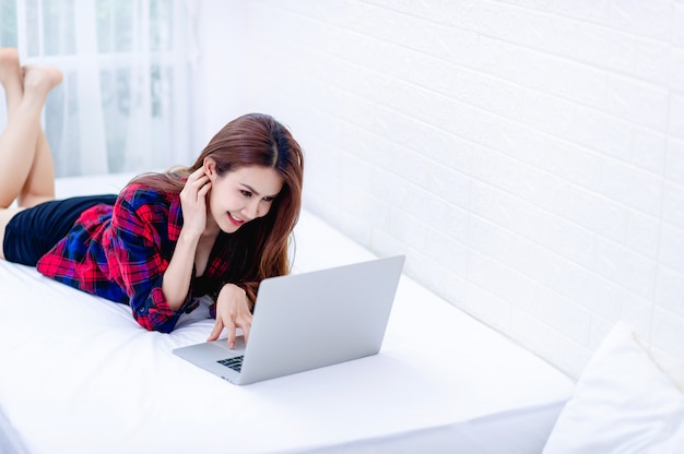 The woman and the computer in the white room Happy work The concept of happy working at home