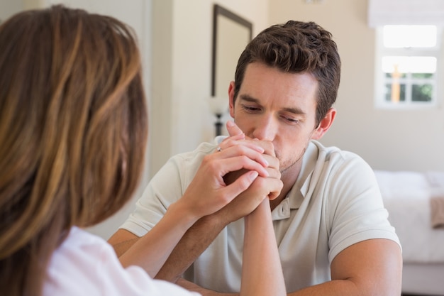 Woman consoling a sad young man