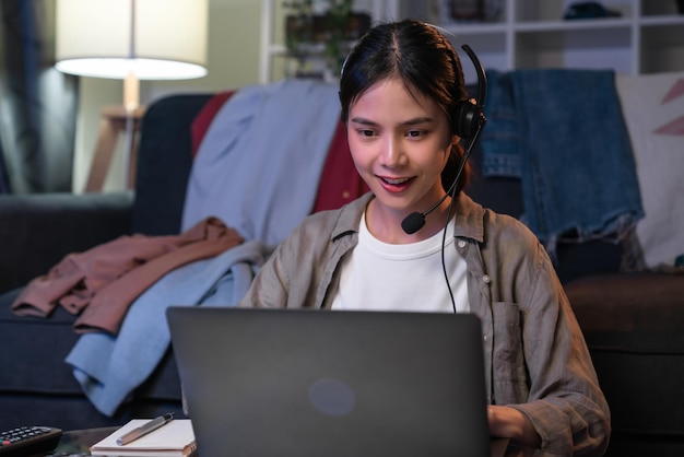 Woman consultant wearing microphone headset of customer support phone operator at home office.