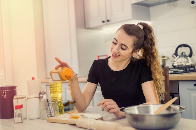 Woman cooking bakery eat, mixing ingredients: flour, eggs, oil and other.