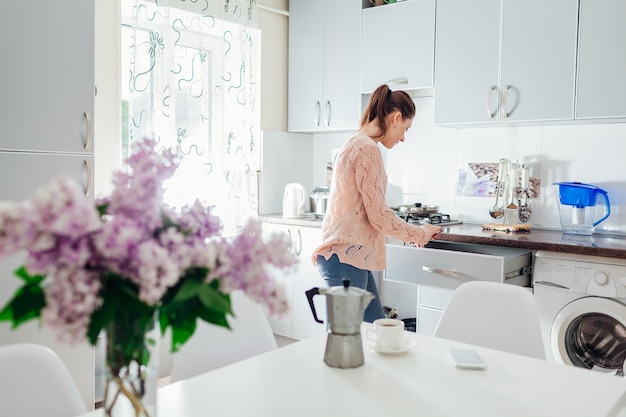 Woman cooking dinner and having coffee on the kitchen Modern kitchen design