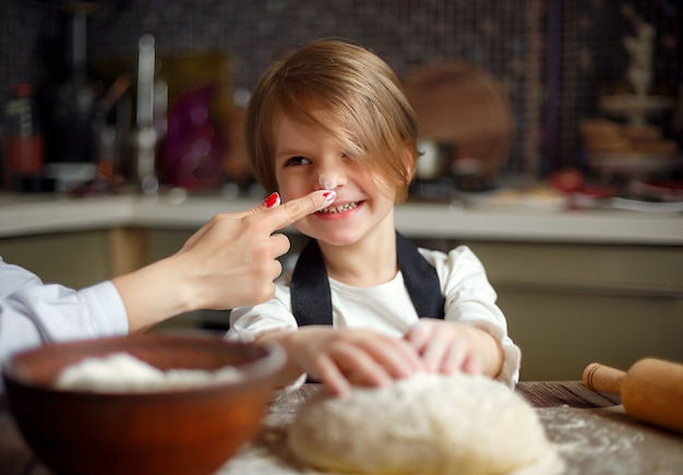 Woman cooking and having fun with little girl