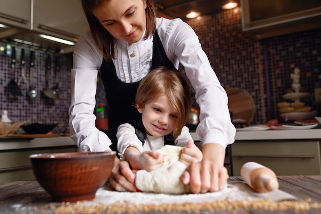 Woman cooking with little girl