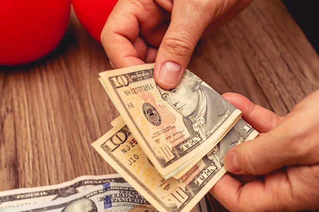 a woman counting american dollars banknotes for money making concept