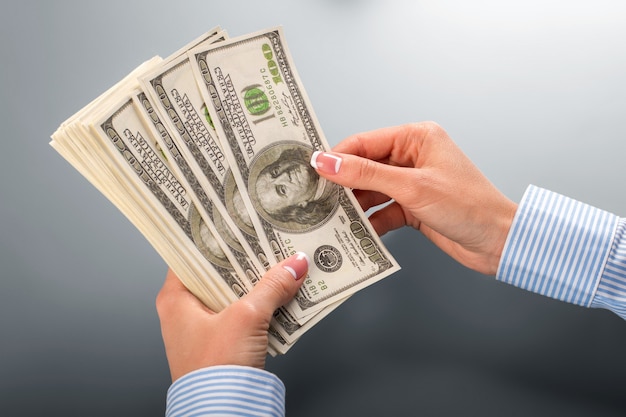 Woman counting bunch of dollars. Female hands counting dollars. Let&amp;#39;s start counting. I wonder if they lied.