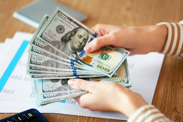 Woman counting money at the table