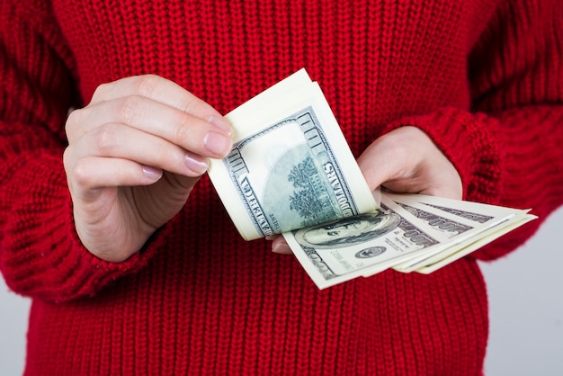 Woman counting paper money in hands