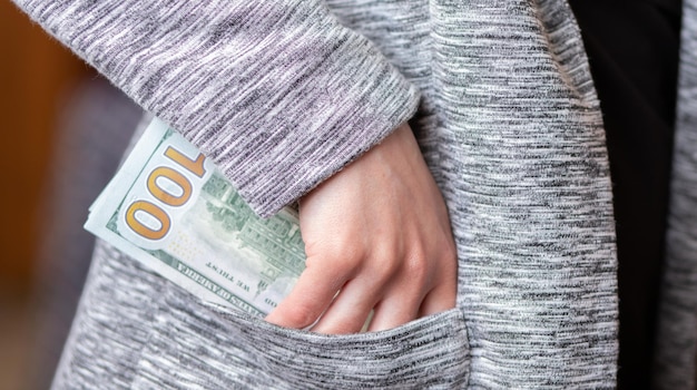 Woman counts money female hands hold cash banknotes denominations of 100 dollars