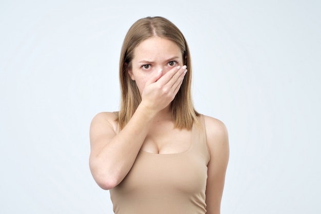 Woman covering mouth with hand