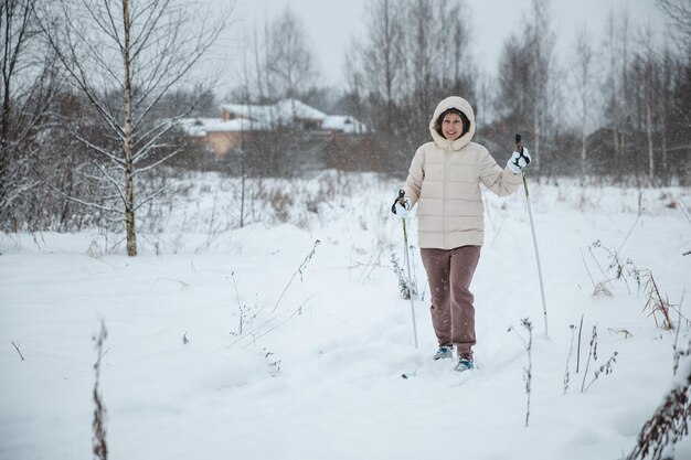 A woman on crosscountry skiing in a winter forest a healthy lifestyle concept a sporty lifestyle