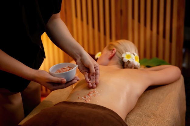 Woman customer having exfoliation treatment in luxury spa quiescent