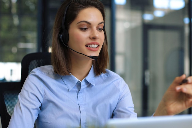 Woman customer support operator with headset and smiling