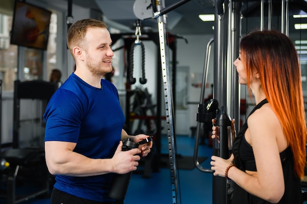 Woman customer talk to gym trainer coach