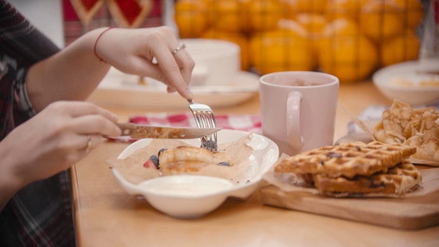 A woman cutting a pancake in the plate