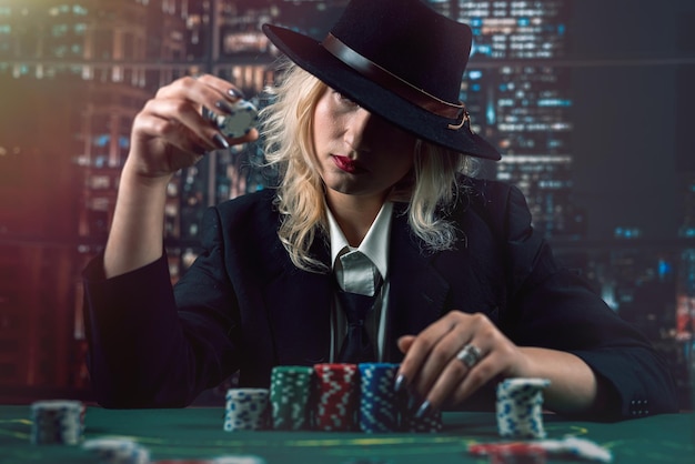 Woman dealer or croupier shuffling poker cards in casino holding two playing cards Casino poker