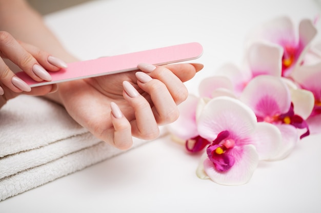 Photo woman demonstrates a fresh manicure