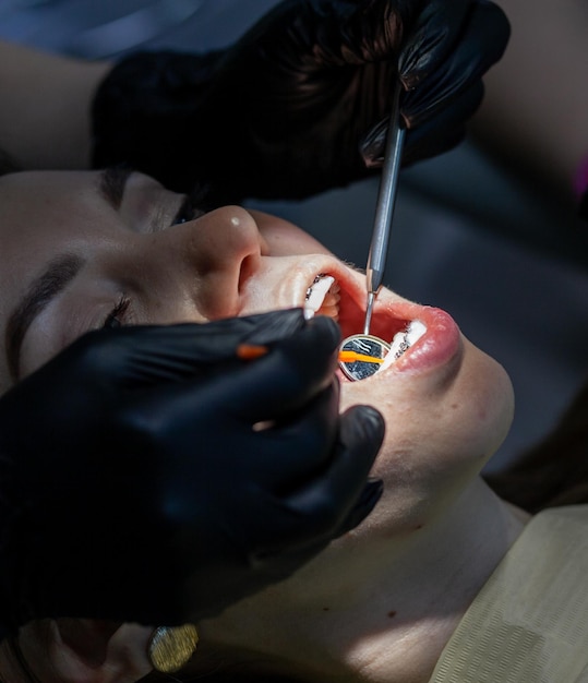 A woman at a dentist39s appointment to replace arches with braces