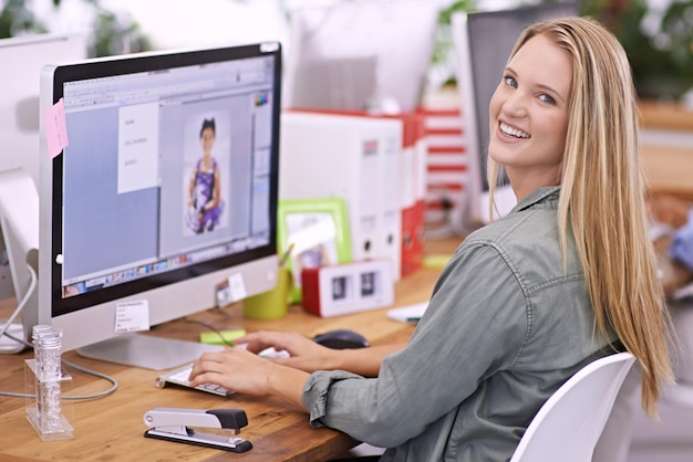 Woman at desk computer screen and smile in portrait editor at fashion magazine Young professional female image editing software for publication with creativity and editorial career with design