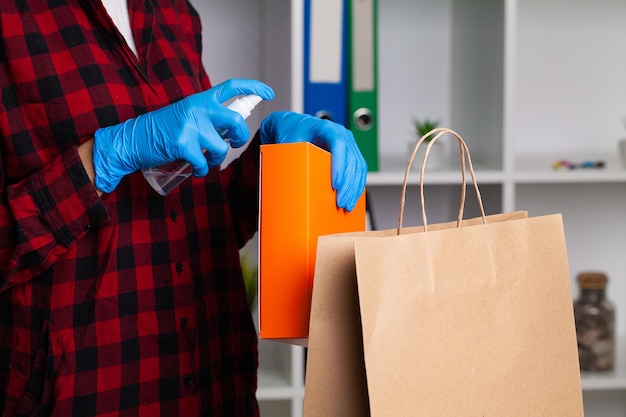 A woman disinfects parcels before unpacking them at home to avoid the possibility of being infected