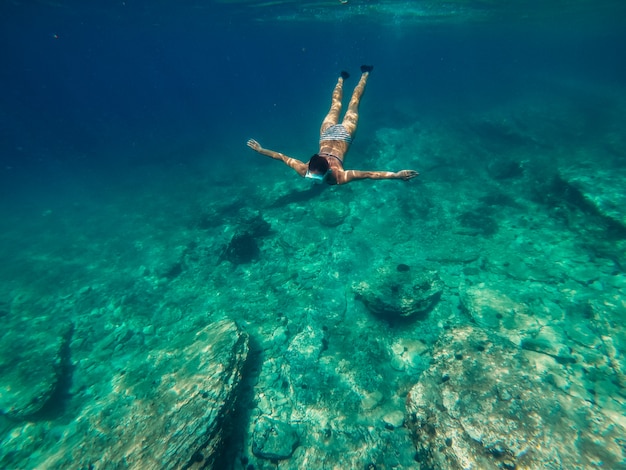 Woman diving into the shallow sea water