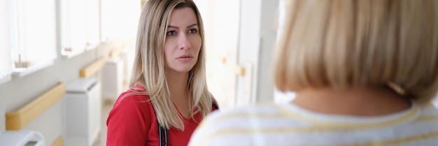 Woman doctor communicates with patient in corridor of hospital