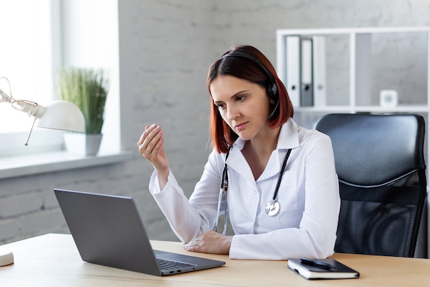 Woman Doctor consults by video call Online medical assistance.