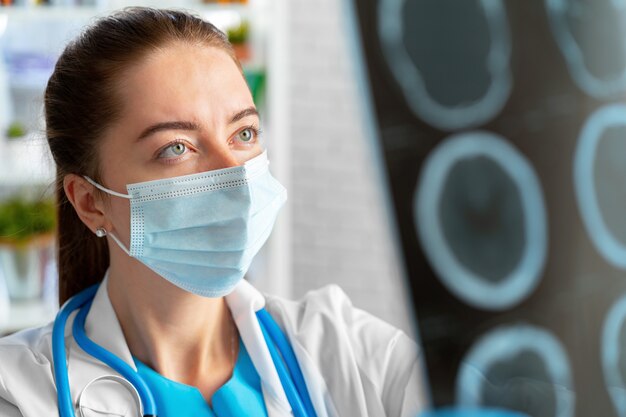 Woman doctor examines head mri scan in hospital