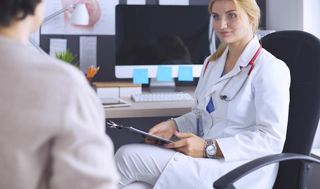 Woman doctor explaining diagnosis to her female patient