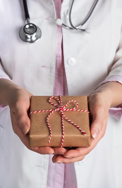 Woman doctor holding christmas gift