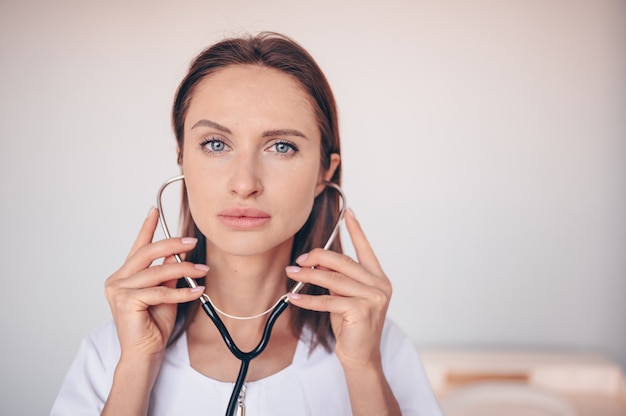 Woman doctor nurse with stethoscope for check breathing