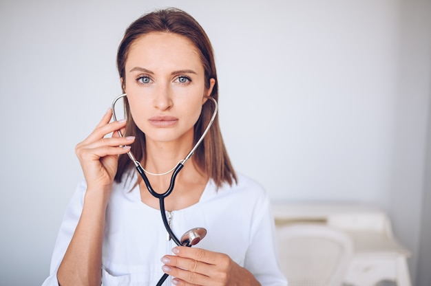 Woman doctor nurse with stethoscope for check breathing