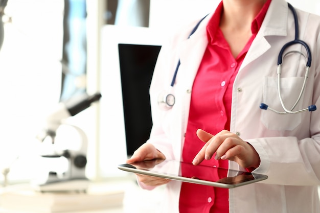 Woman Doctor Using Black Screen Computer Tablet