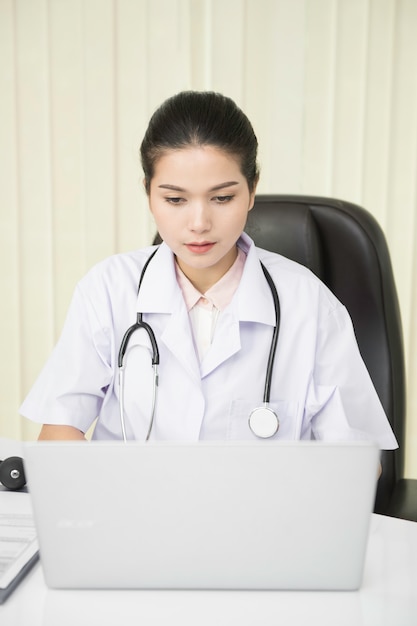 Woman doctor using laptop 