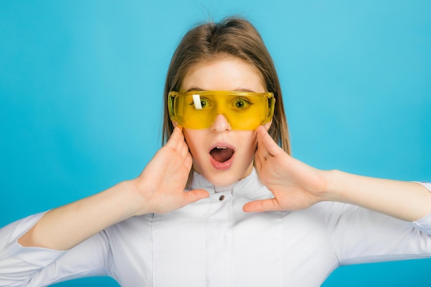 Woman doctor in yellow glasses on blue background