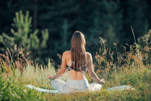 A woman does yoga in the open air The concept of sport