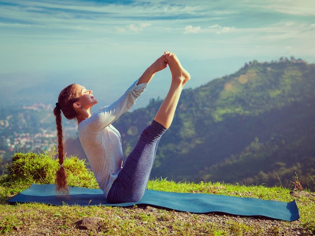 Woman doing Ashtanga Vinyasa Yoga asana outdoors