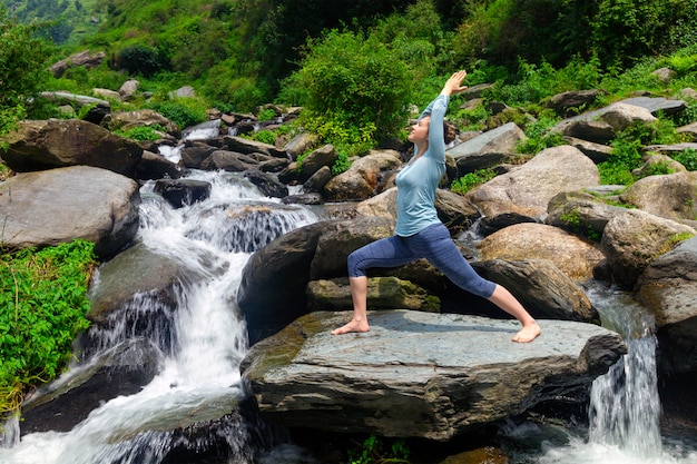 Woman doing Ashtanga Vinyasa Yoga asana Virabhadrasana 1 Warrior