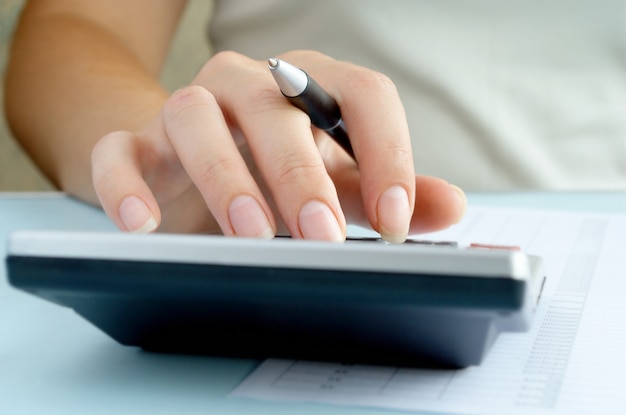 Woman doing calculations on a calculator