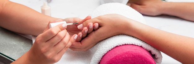 Woman doing her manicure at the salon