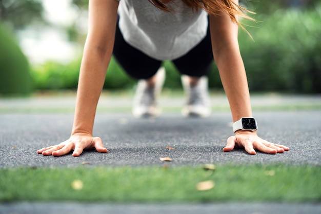 Woman doing push ups in the park